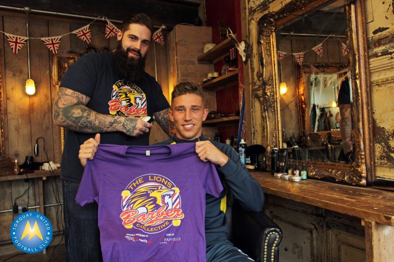Tom Chapman, founder of the Barber Collective, with Torquay United defender Angus MacDonald